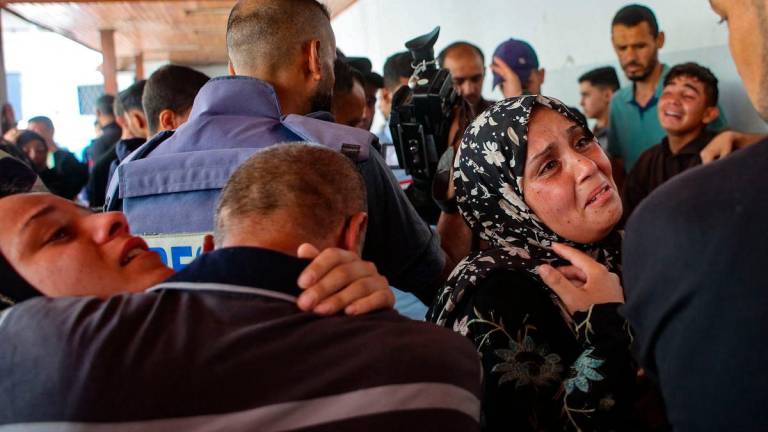 Relatives mourn the death of three Palestinian journalists reportedly killed in Israeli bombardment in the yard of the Ahli Arab Hospital, in Gaza City. AFPPIX