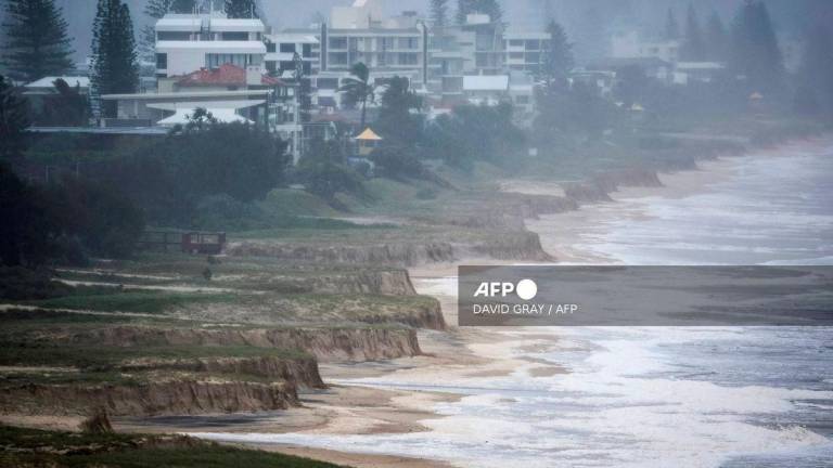 (FILES) A file photo taken on March 9, 2025 shows a general view of erosion at Miami Beach after the sand was washed away during Tropical Cyclone Alfred on the Gold Coast. Rising oceans caused by climate change will threaten 1.5 million Australians by 2050, a landmark report warned on September 15, 2025 ahead of Australia releasing its emission targets this week. (Photo by David GRAY / AFP)