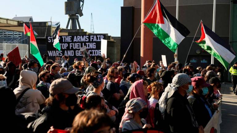 Demonstrators with Palestinian flags protest against UK arms exports and Israeli weapons firms, amid the war in Gaza, outside the Defence and Security Equipment International (DSEI) arms fair in London, Britain, September 9, 2025. REUTERS/Jack Taylor