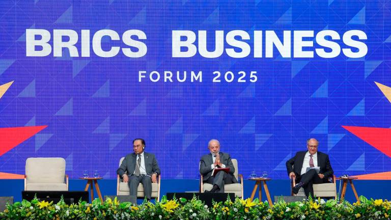 Malaysia’s Prime Minister Anwar Ibrahim, Brazil’s President Luiz Inacio Lula da Silva and Brazil’s Vice President Geraldo Alckmin participate at the opening of the BRICS Business Forum, ahead of the BRICS Presidential Summit, in Rio de Janeiro, Brazil, July 5, 2025. - REUTERS/Pilar Olivares