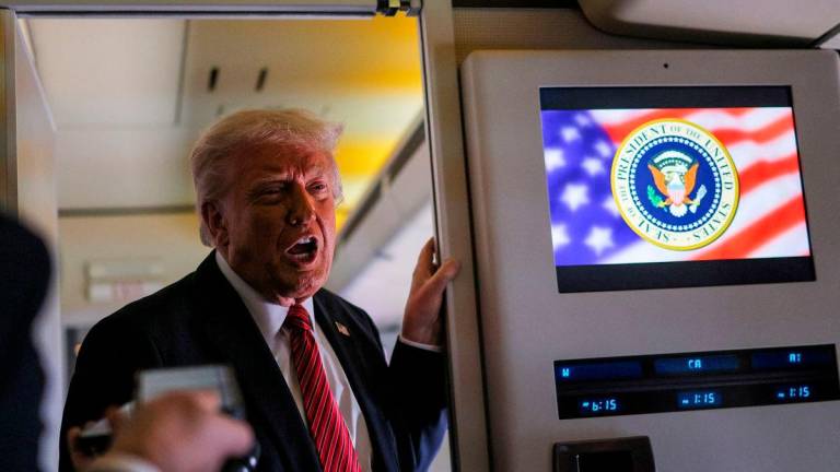 Trump speaks to the press on board Air Force One en route to Doha, Qatar, May 14, 2025. REUTERSpix