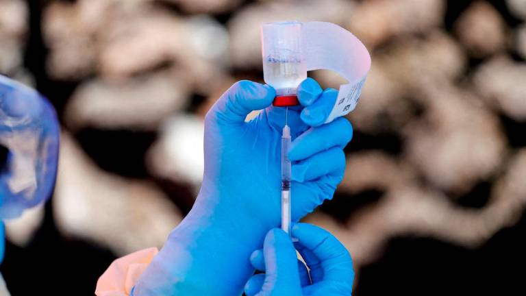 FILE PHOTO: A health worker fills a syringe with Ebola vaccine before injecting it to a patient, in Goma, Democratic Republic of Congo, August 5, 2019. REUTERS/Baz Ratner/File Photo