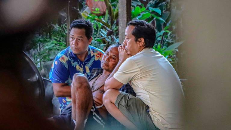 Family members of one of the crew members of Air India flight 171 mourn at their house - AFPPIX