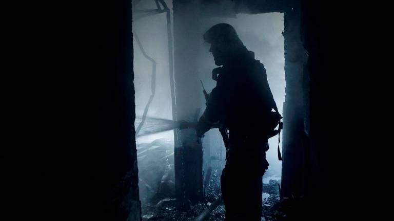 A firefighter works at the site of the building hit by a Russian drone strike, amid Russia’s attack on Ukraine, in Kharkiv, Ukraine July 7, 2025. - REUTERS/Sofiia Gatilova