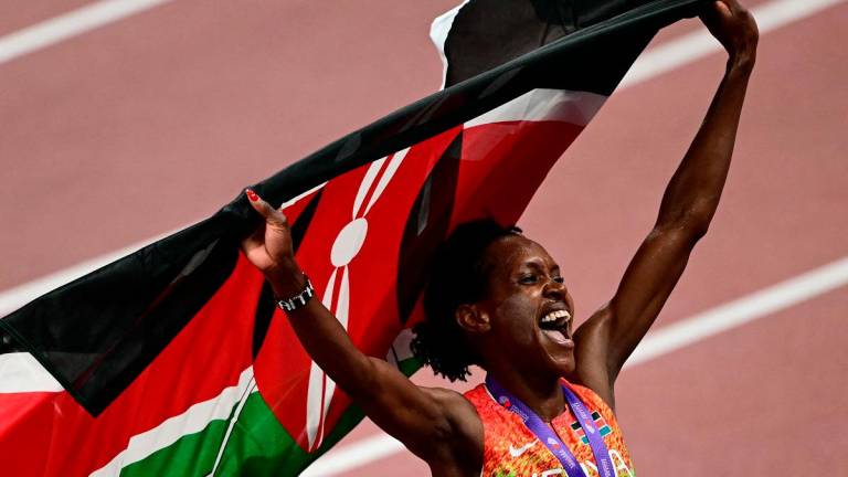 Kenya’s Faith Kipyegon celebrates after winning the women’s 1500m final. - Yuichi YAMAZAKI / AFP