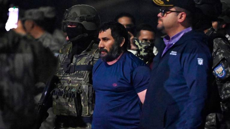 Drug trafficker Adolfo Macias, alias Fito, is guarded by Ecuador’s Interior Minister John Reimberg (R) and military personnel upon arrival at the air base in Guayaquil, Ecuador, on June 25, 2025 - Photo by Marcos PIN / AFP