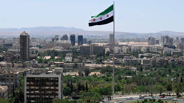 A large Syrian flag flutters above Tishreen Park in Damascus on June 4, 2025. - LOUAI BESHARA / AFP