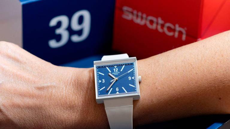 A model from Swiss watchmaker Swatch named “WHAT IF...TARIFFS?” with the numbers 3 and 9 reversed on its face, as a play on the 39% import tariffs that U.S. President Donald Trump slapped on Switzerland last month, is pictured on wrist at a Swatch shop in Geneva, Switzerland, September 12, 2025. REUTERS/Pierre Albouy