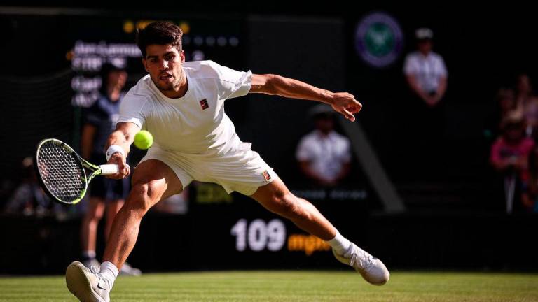 Spain’s Carlos Alcaraz plays a forehand return to Germany’s Jan-Lennard Struff during their men’s singles third round tennis match on the fifth day of the 2025 Wimbledon Championships at The All England Lawn Tennis and Croquet Club in Wimbledon, southwest London, on July 4, 2025- AFP