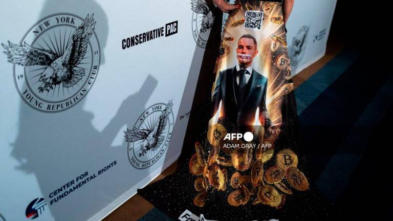 A person wears a dress with an image of Bitcoin investor Roger Ver at the New York Young Republican Club’s Annual Gala at Cipriani’s Wall Street in New York City. Photo by ADAM GRAY / AFP