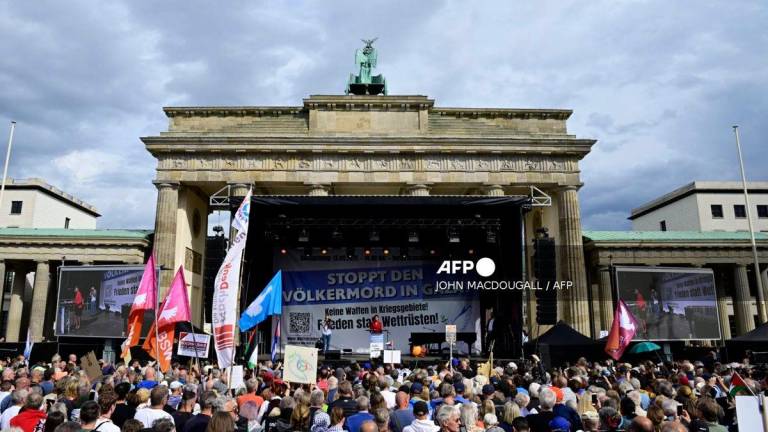 A general view shows Sahra Wagenknecht, co-founder and co-leader of the left-wing populist party Sahra Wagenknecht Alliance (BSW), as she speaks on a stage during a rally titled “Stop the genocide in Gaza! No weapons in war zones! Peace instead of arms race!” on September 13, 2025 at the Brandenburg Gate in Berlin. (Photo by John MACDOUGALL / AFP)