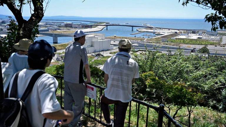 People watch the coastal area from Hiyoriyama Park after Japan issued evacuation alert following major quake in Russia’s Kamchatka Peninsula that triggered a tsunami warning, in Ishinomaki, Miyagi prefecture, Japan July 30, 2025 - Kyodo/via REUTERSPix
