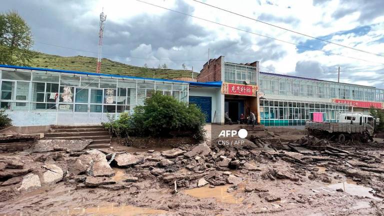 A road is damaged after a flash flooding caused by a sudden downpour triggered mudslides in Datong county, Xining city, in China’s northwestern Qinghai province on August 18, 2022. - CNS / AFP