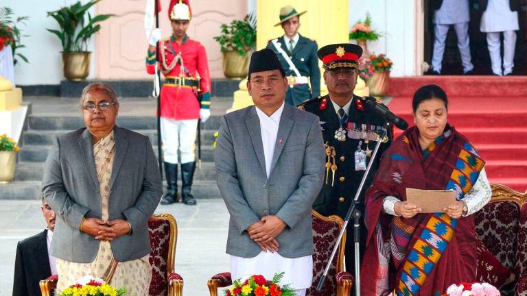 (FILES) Nepal’s newly elected Prime Minister Pushpa Kamal Dahal (not pictured) is sworn in by Nepalese President Bidhya Bhandari (R) as Vice President Nanda Kishor Pun (C) and the country’s Chief Justice Sushila Karki (L) look on during the ceremony at the President House in Shital Niwas in Kathmandu on August 4, 2016. Nepal’s former chief justice Sushila Karki is the leading choice to be interim leader, a representative of the “Gen Z” protesters said on September 11, 2025 after demonstrations that ousted the veteran prime minister. Photo by Prakash MATHEMA / AFP