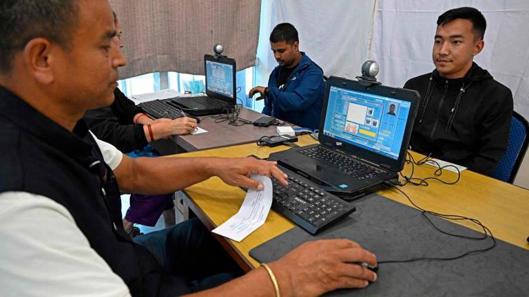 Youths register themselves for the upcoming Nepal’s parliamentary elections, in Kathmandu on October 13, 2025. - Prakash MATHEMA / AFP