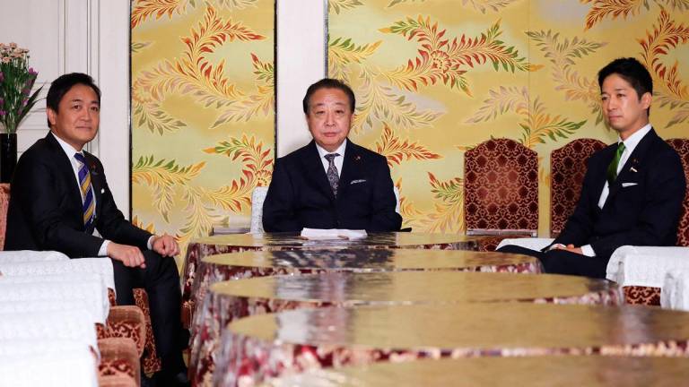 Leaders of three major Japanese opposition parties, leader of the Democratic Party for the People Yuichiro Tamaki (L), head of the largest opposition Constitutional Democratic Party of Japan Yoshihiko Noda (C) and co-leader of the Japan Restoration Party Fumitake Fujita, attend a meeting in the Diet in Tokyo on October 15, 2025. - JIJI PRESS / AFP