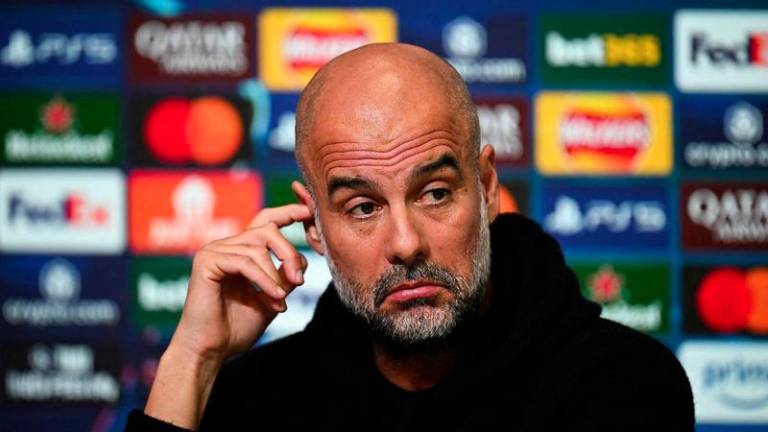 Manchester City's Spanish manager Pep Guardiola reacts as he speaks during a press conference at Manchester City's training ground in Manchester, north-west England, on February 10, 2025, on the eve of their UEFA Champions League football match against Real Madrid. - AFPPIX