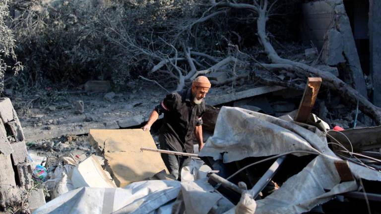 A Palestinian man checks the damage in the aftermath of an overnight Israeli strike that hit Nuseirat in the central Gaza Strip on July 13, 2025. (Photo by Eyad BABA / AFP)