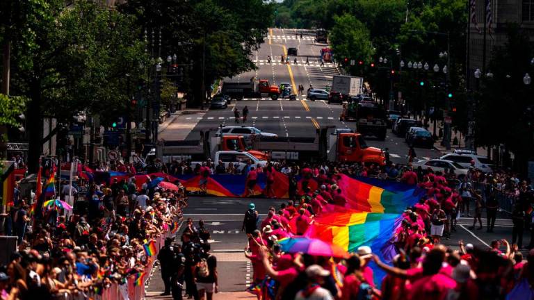 Activists with the Gilbert Baker Foundation carry a 1,000-foot Rainbow Flag along the parade route during the WorldPride 2025 Celebrations on June 7, 2025 in Washington, DC. AFP