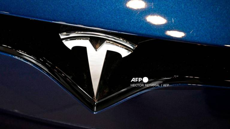 (FILES) A Tesla car is seen at a showroom for the US electric vehicle maker in the Jing'an district in Shanghai on April 9, 2025. - AFP