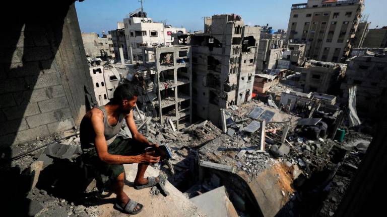 A Palestinian looks on at the site of Thursday’s Israeli strike that damaged and destroyed residential buildings, at Shati (Beach) refugee camp, in Gaza City, July 4, 2025. REUTERS