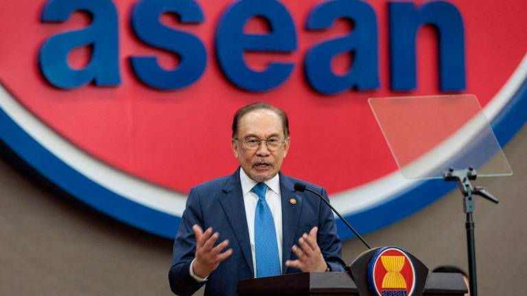 Prime Minister Anwar Ibrahim delivers a speech at the Association of Southeast Asian Nations (ASEAN) Secretariat in Jakarta on July 29, 2025. (Photo by YASUYOSHI CHIBA / AFP)