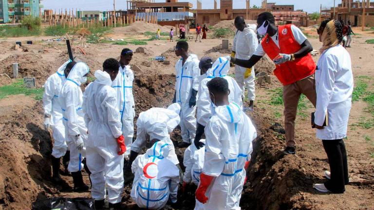 Members of the Sudanese Red Crescent and forensic experts exhume the remains of people from makeshift graves for reburial in the local cemetery in Khartoum’s southern suburb of al-Azhari on August 2, 2025 after the dead were buried in a rush when the area was under control of the Rapid Support Forces (RSF) paramilitaries. AFPPix