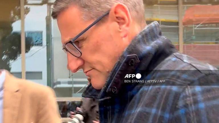 This frame grab taken from AFPTV footage on August 4, 2025 shows New Zealand’s former deputy police commissioner Jevon McSkimming leaving court after he was charged with possessing child sexual exploitation and bestiality material in Wellington. (Photo by Ben STRANG / AFPTV / AFP)