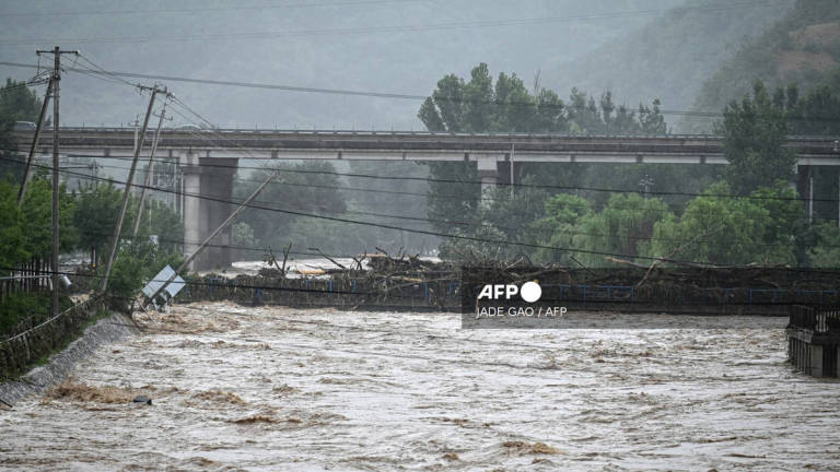 A flooded area is seen after heavy rains at Xin'anzhuang village, in Miyun district, on the outskirts of Beijing on July 28, 2025. - AFP