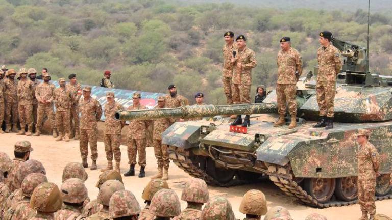 This handout photograph taken on May 1, 2025 and released by the Pakistan’s Inter Service Public Relation (ISPR) shows Pakistan’s Army Chief General Syed Asim Munir (Top 3R) standS on military tank speaks with army troops to witness exercise ‘Hammer Strike’ a high-intensity field training exercise conducted by Pakistan Army’s Mangla Strike Corps at the Tilla Field Firing Ranges (TFFR) in Jhelum, Punjab province. AFPpix