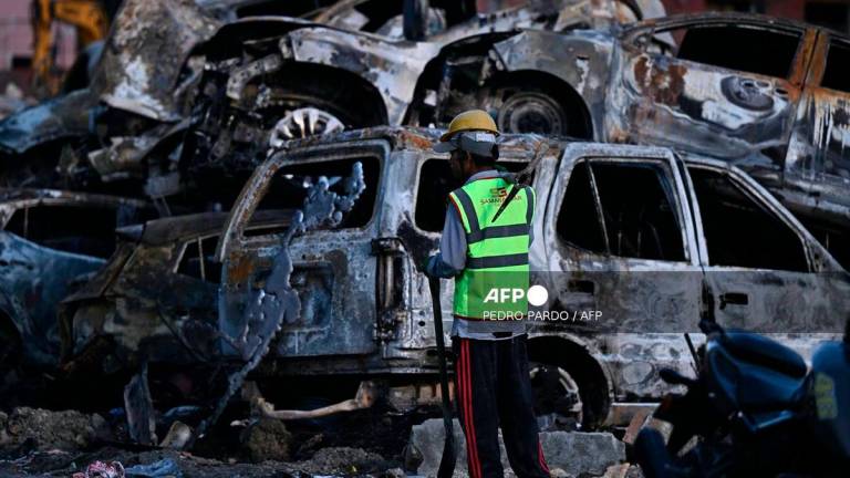 Burnt cars are pictured outside the Supreme Court during a curfew imposed to restore law and order in Kathmandu on September 11, 2025. - AFP