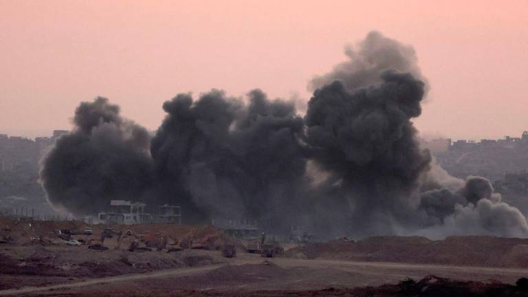 This picture taken from a position at Israel’s border with the Gaza Strip shows smoke billowing during an Israeli strike on the besieged Palestinian territory on July 8, 2025. (Photo by Jack GUEZ / AFP)