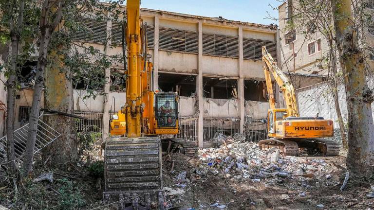 (FILES) Excavators are used to clear the rubble outside the Evin prison complex in Tehran that was hit days ago by an Israeli strike. - Mostafa Roudaki / MIZANONLINE / AFP
