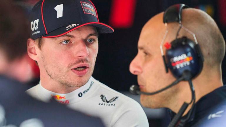 Red Bull Racing’s Dutch driver Max Verstappen (L) speaks with a team member in the garage near pit lane during the second practice session for the 2025 Formula 1 Grand Prix du Canada at Circuit Gilles-Villeneuve in Montreal, Canada, on June 13, 2025. AFPpix