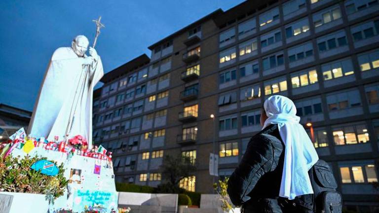 Nuns pray at the feet of a statue of John Paul II at the Gemelli Hospital where Pope Francis is hospitalised, in Rome. AFPpix