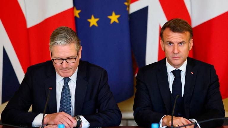 Britain’s Prime Minister Keir Starmer (L) and France’s President Emmanuel Macron attend the UK-France Summit at 10 Downing Street in London, on July 10, 2025, the final day of Macron’s three-day state visit to Britain. - Gonzalo Fuentes / POOL / AFP