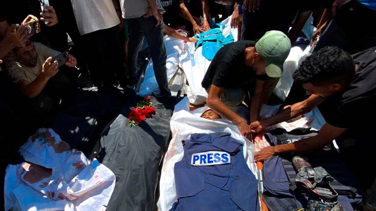 People mourn over the bodies of Palestinian journalists killed in an Israeli strike on Nasser Hospital, ahead of their funeral in Khan Yunis in the southern Gaza Strip on August 25, 2025. - AFPpix