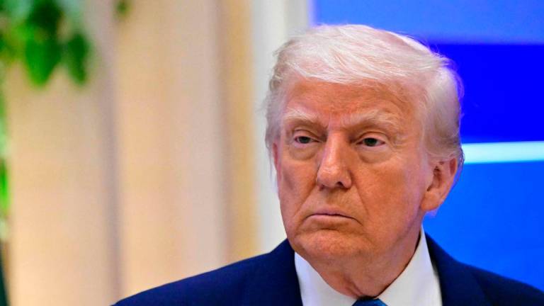 US President Donald Trump attends a business forum in Abu Dhabi on May 16, 2025. Trump capped his Gulf tour in Abu Dhabi after signing another raft of multi-billion-dollar deals, while also securing a $1.4 trillion investment pledge from the UAE. AFPpix