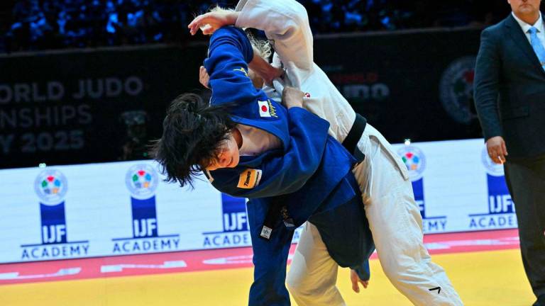 Japan's Shiho Tanaka (blue) competes against Croatia's Lara Cvjetko during the women's -70kg fianl bout of the Judo World Championships at the Papp Laszlo Arena in Budapest, Hungary, on June 17, 2025. - AFPPIX
