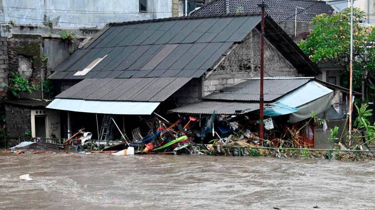 A house is inundated by floodwaters following heavy rain in Denpasar, Indonesia’s Bali island, on September 10, 2025. (Photo by SONNY TUMBELAKA / AFP)
