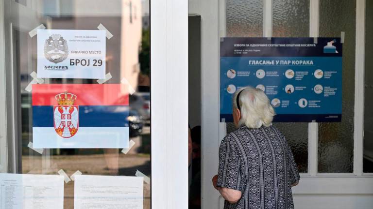A woman enters at a polling station during the local elections in Kosjeric town, Serbia,in Kosjeric, a town of 10,000 in western Serbia, on June 8, 2025. AFPpix
