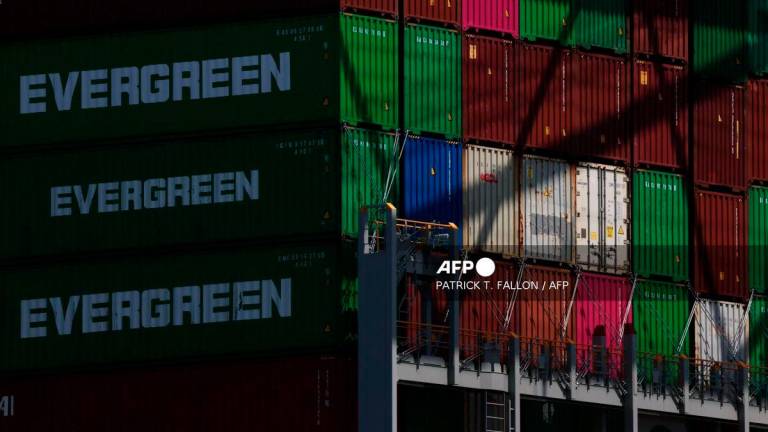 Evergreen cargo shipping containers stand stacked on a cargo container ship docked at the Evergreen shipping terminal at the Port of Los Angeles in Los Angeles, California on September 13, 2025. - AFP