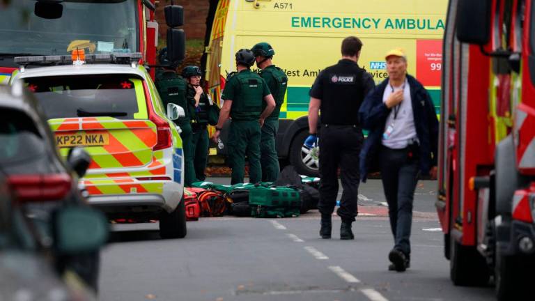 Emergency personnel work at the scene following an incident outside a synagogue in north Manchester, Britain, October 2, 2025. REUTERS/Phil Noble