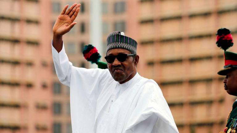 Nigerian President Muhammadu Buhari waves at the crowd while he drives around the venue during his inauguration for a second term in Abuja, Nigeria, May 29, 2019. - REUTERSPIX