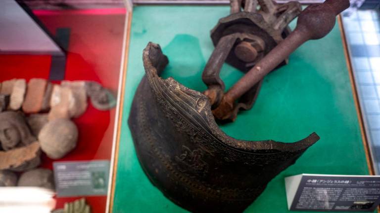 This picture taken on August 8, 2025 shows part of the tower bell (bell of the Angelus), which was destroyed by the atomic bomb, at the atomic bomb relics exhibition room of Urakami Cathedral in Nagasaki city. AFPPix