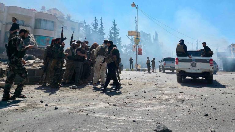 Syria's security forces enter the predominantly Druze city of Sweida on July 15, 2025, following clashes between Bedouin tribes and Druze fighters. Syrian government forces entered the majority Druze city of Sweida on July 15, 2025, the interior ministry said, aiming to end clashes with Bedouin tribes that have killed nearly 100 people. - Sam HARIRI / AFP