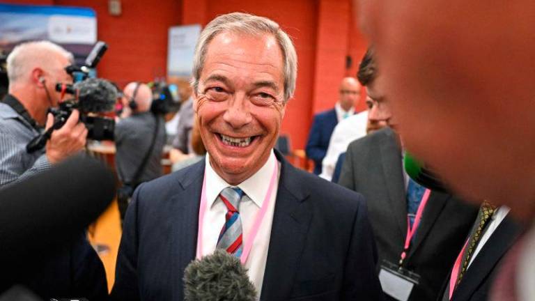Nigel Farage (C), leader of the Reform UK party, speaks with the press as he celebrates the victory of Sarah Pochin, the party’s candidate, in the Runcorn &amp; Helsby by-election at the DCBL Stadium in Widnes, north-west England, in the early hours of May 2, 2025. AFPpix