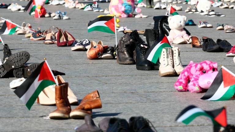 This photograph shows shoes laid out on Place Kleber symbolising Palestinians killed during over Israel’s offensive on the Gaza strip, in Strasbourg, eastern France, on September 20, 2025, as part of a symbolic action named “Operation Shoes – Lives, not just numbers!” by the Collectif Palestine 67. (Photo by Frederick FLORIN / AFP)