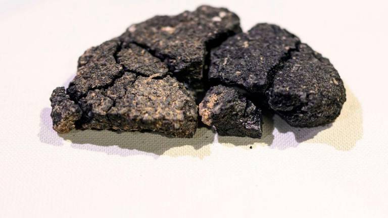 This photograph shows Kulluoba bread, a 5,000 years old bread unearthed in an archeological excavation in Eskisehir province, in central Turkey, exhibited at Eskisehir ETI archeology museum, on May 23, 2025. AFPpix