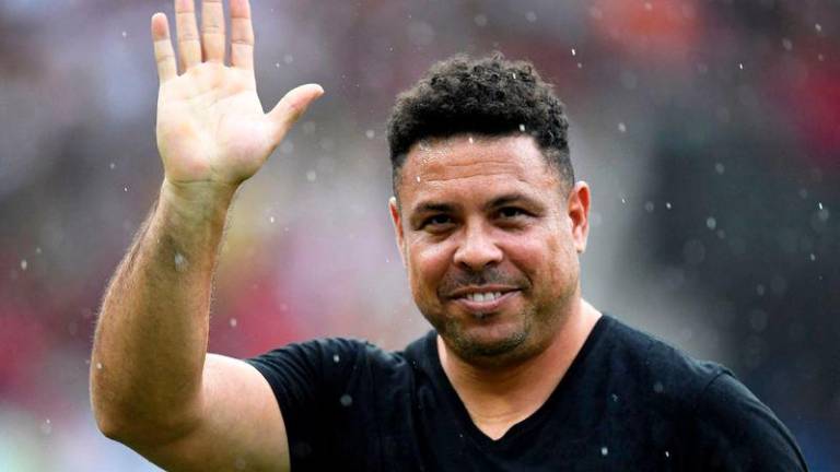 Brazilian former football star Ronaldo waves to the crowd during a friendly match with legends of Brazil's Flamengo and Italy's Inter Milan as farewell of former brazilian player Adriano at Maracana Stadium in Rio de Janeiro on December 15, 2024. - AFPPIX